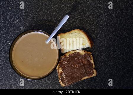 French breakfast with bowl of coffee and brioche and chocolate spread Stock Photo
