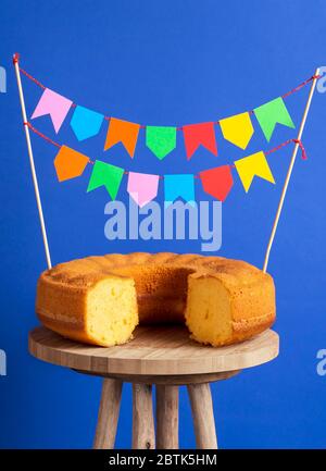 Party flags stuck in a cornmeal cake. Sweet food ready for the famous brazilian celebration called Festa Junina Stock Photo