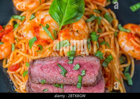 Spaghetti surf and turf basil close-up Stock Photo