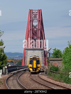 Scotrail class 158 express sprinter train 158728 running off the Forth railway bridge seen from Dalmeny. Stock Photo