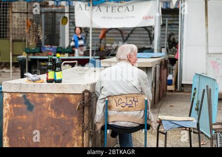 A lone male vendor with only 2 bottles of homemade olive oil for sale at Split's Green Market, Croatia
