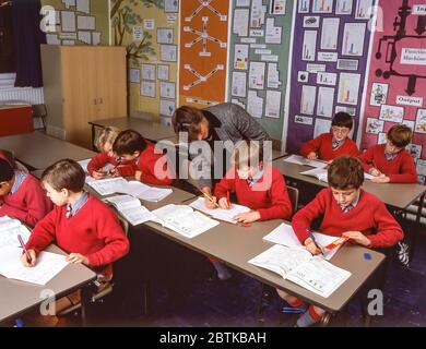 Schoolboys and teacher in maths class, Surrey, England, United Kingdom Stock Photo