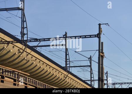 Detail of a modern train station and interlaced high voltage cables Stock Photo