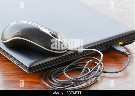 Closed notebook and a mouse on the table in the office Stock Photo