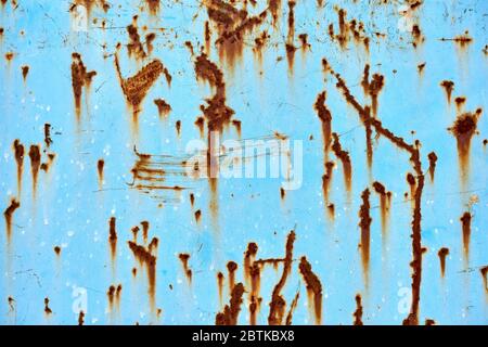 Blue metal surface with brown rusted spots. Stock Photo