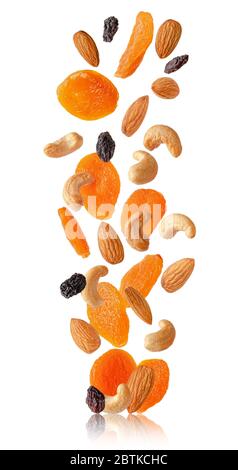 Flying dry fruits and nuts isolated on white. Stock Photo