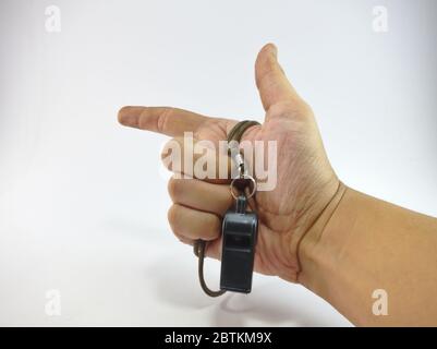 The handler holds the whistle in various gestures. Stock Photo