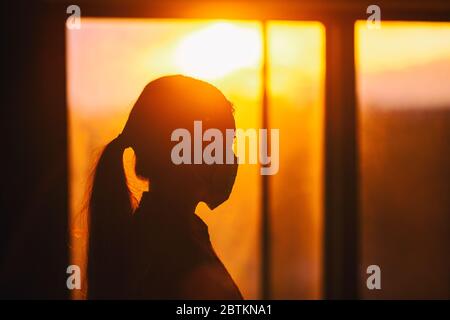 COVID-19 healthcare worker inside hospital wearing mask silhouette woman walking. Concept for anxiety, social distancing impact of coronavirus. Stock Photo