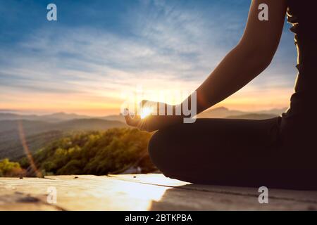 Yoga woman, meditation, yoga poses.close up of female in lotus position meditating in the mountains. happiness living vitality health balance recreati