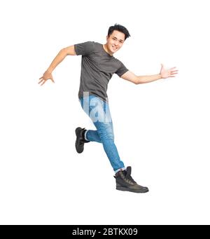 happy young asian man dancing and jumping isolated on white Stock Photo