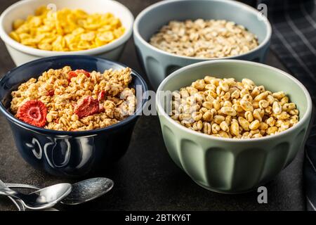 Various breakfast cereals in bowls. Puffed wheat and oatmeals. Stock Photo