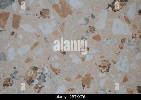 Close-up light marble mosaic with splashes of gray and beige. Background, texture. Stock Photo