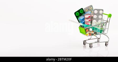 Supermarket trolley filled with pharmaceutical tablets and capsules Stock Photo