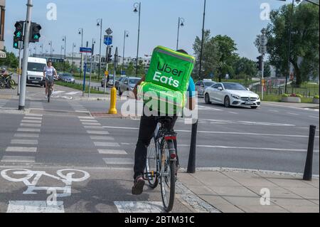 WARSAW, POLNAD - June 15, 2019: UberEATS cycle delivery courier. Uber Eats delivery in progress on Warsaw street - Poland. UberEATS is online food ord Stock Photo