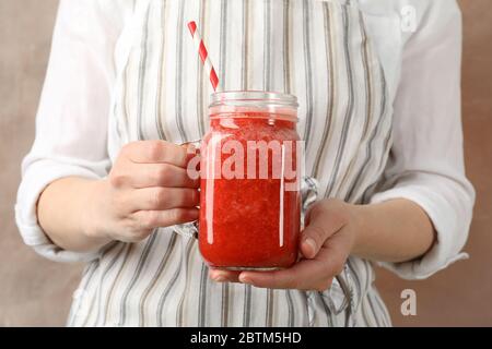 Woman hold glass jar of strawberry cocktail, close up. Summer drink Stock Photo