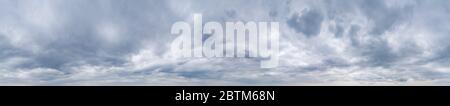 Large panorama of cloudy gray sky with thick dense clouds. Stock Photo