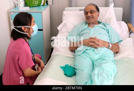 Patient Hitesh Patel talks to doctor Jasmine Gan on a Covid recovery ward at Wexham Park Hospital near Slough. Picture date: 22/5/2020. Stock Photo