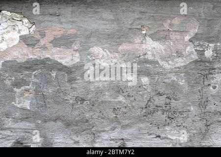 Old cracked wall covered with stucco with abstract watercolor blue, pink and ebony spots of paint. Multicolored vintage background for wallpaper, background and scrapbooking.  Stock Photo