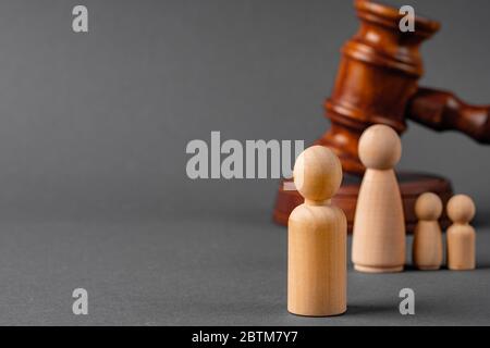 Wooden toy family and judge mallet. Family divorce concept Stock Photo