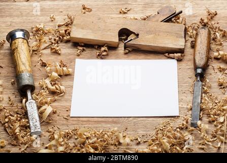 carpenter tools on dark rustic table with blank paper. Stock Photo