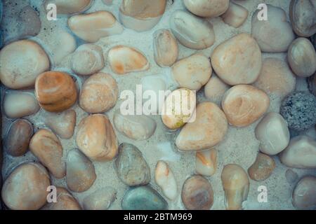 Sea stones in the sea water. Pebbles under water. The view from the top. Nautical background. Clean sea water. Transparent sea. Stock Photo