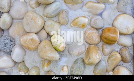 Sea stones in the sea water. Pebbles under water. The view from the top. Nautical background. Clean sea water. Transparent sea. Stock Photo