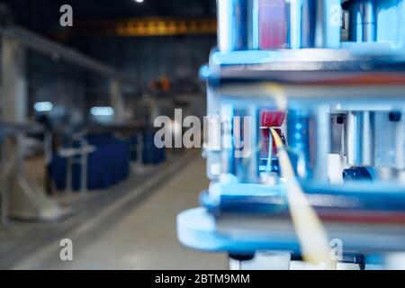 Inside a modern plant producing power electric cables and optical fibers. .Cable manufacturing machine part. Stock Photo