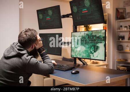 Side view adult hacker working on computer cyber crime. Angry hacker gets access denied. Stock Photo