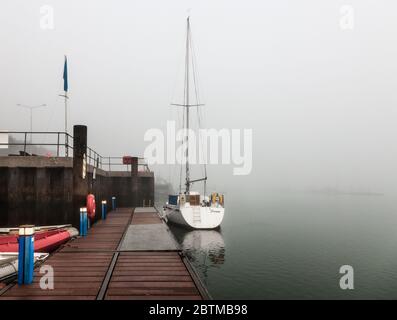 Crosshaven, Cork, Ireland. 27th May, 2020. Early morning fog shrouds the yacht Jocanti which is tied up at the pier in Crosshaven, Co. Cork, Ireland.  Weather forcast for the day is that coastal fog will clear and become sunny everywhere with tempertures ranging between 20 to 24 degrees celcius.  - Credit; David Creedon / Alamy Live News Stock Photo