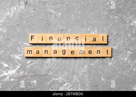 Financial Management word written on wood block. Financial Management text on cement table for your desing, concept. Stock Photo