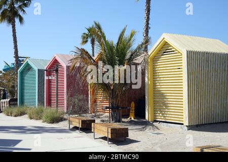 Dubai, United Arab Emirates - March 28, 2020:  Original wooden cabins  for changing and storing equipment are installed on the city public sea beach Stock Photo