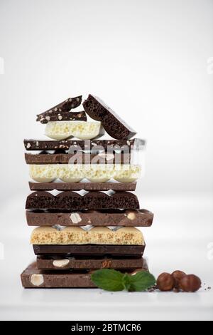 Different kinds of chocolates with nuts cocoa powder and mint - selective focus, white background Stock Photo