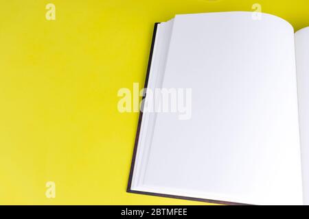 Empty book booklet mockup with blank pages and copy space on yellow background. Top view. Template for magazine, portfolio and catalogue Stock Photo
