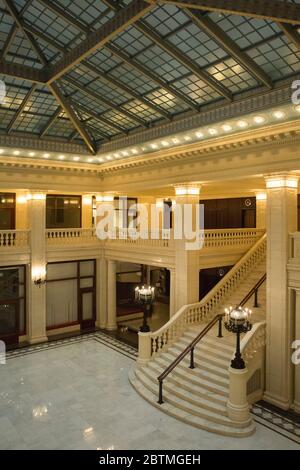 Vertical view of a corner of the main hall of the Railway Exchange Building and its stairway from the first floor balcony, Chicago, Illinois, USA Stock Photo