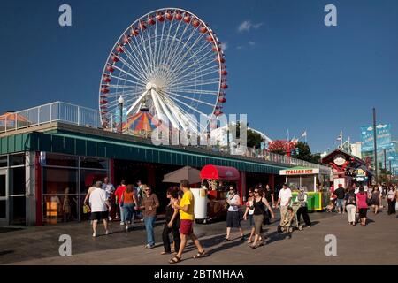 Horizontal beautiful summer shot of the visitors of the colorful Navy Pier waterfront and its retro Ferris wheel before its last remodeling, Chicago Stock Photo