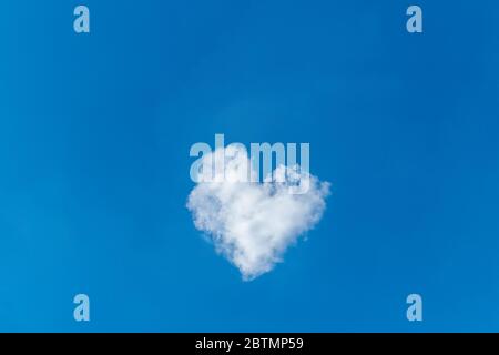 Romantic cloud in the shape of a heart on a blue sky. Love concept.
