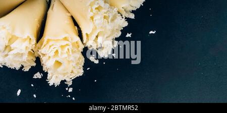 https://l450v.alamy.com/450v/2btmr52/swiss-cheese-tete-de-moine-or-monastery-monks-head-scraped-with-a-girolle-special-knife-rosettes-on-a-dark-slate-background-copy-space-selective-2btmr52.jpg