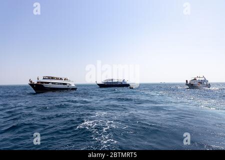 Hurghada, Egypt - september 17, 2019: Unknown people on white yacht watching dolphins in the Red sea, Jaz 'ir Jift n Stock Photo