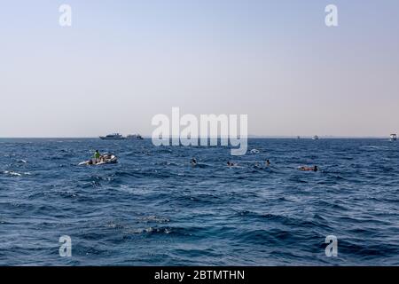 Hurghada, Egypt - september 17, 2019: Unknown people on a dinghy watching dolphins in the Red sea, Jaz 'ir Jift n Stock Photo