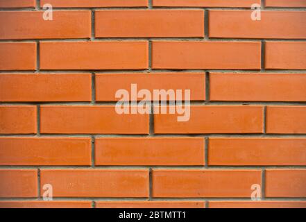 Orange bricks wall close up background. New built brick wall texture. Stock Photo