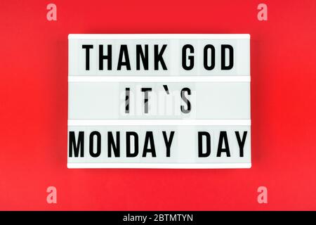 Text Thank God it's Monday day on a lightbox on a red background. Stock Photo
