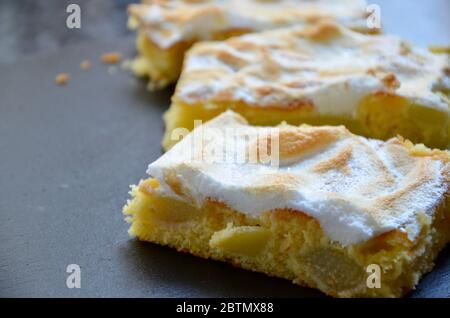 Homemade rhubarb cake with protein meringue topping, pieces on a slate plate, a specialty in Bavaria, Germany, seasonal bakery Stock Photo
