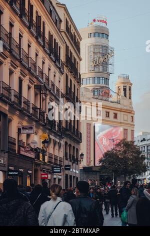 Madrid, Spain - January 26, 2020:View over people of Edificio Capitol on Gran Via, one of the most well-known buildings in Madrid declared a Monument Stock Photo