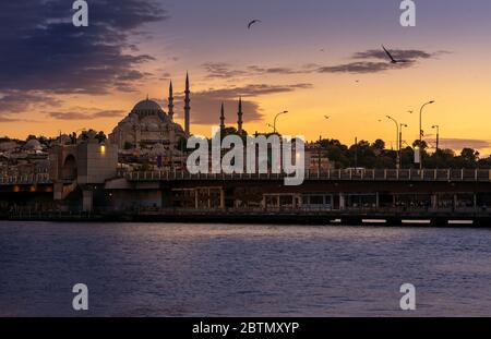 Sunset in Istanbul, Turkey with Suleymaniye Mosque (Ottoman imperial mosque). View with Galata Bridge in Istanbul. Stock Photo