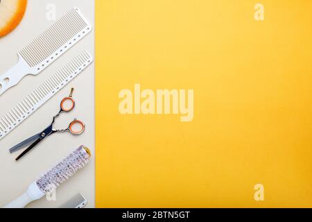 Hairdresser tools, hair salon equipment for professional hairdressing in beauty salon, haircut service. Top view with copy space on orange background Stock Photo