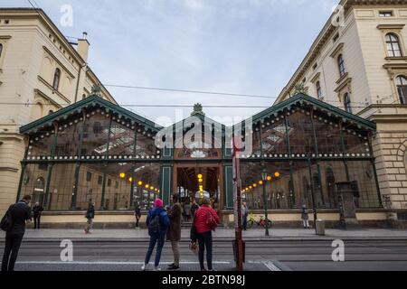 PRAGUE, CZECHIA - NOVEMBER 1, 2019: People waiting for a tram in front of Masarykovo Nadrazi, one of the main train stations of Prague, with commuters Stock Photo