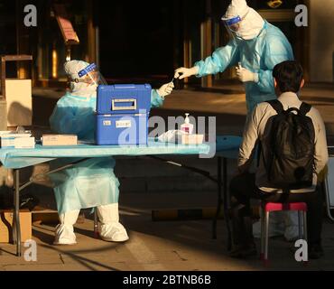 Beijing, China. 27th May, 2020. Foreign correspondents undergo a nucleic acid test (NAT) for the Covid-19 infection by Chinese doctors wearing hazmat suits taking throat swabs prior to being allowed to cover the closing ceremony of the Chinese People's Political Consultative Conference (CPPCC) in Beijing on Wednesday, May 27, 2020. After being postponed from March due to the coronavirus outbreak, the annual CPPCC parliamentary session closed in the capital with over two thousand delegates from across China in attendance. Photo by Stephen Shaver/UPI Credit: UPI/Alamy Live News Stock Photo