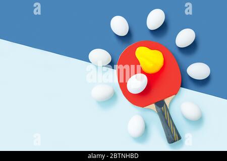 On the racket is a egg and yolk. Next to them are eggs in the form of a halo. Stock Photo