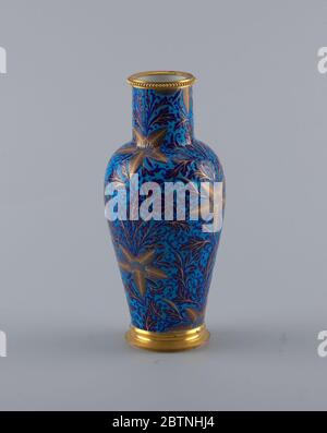 Vase in the Chinois Ly Shape. Research in ProgressA blue porcelain vase with gold details. Vase is decorated with a pattern of large leaves in the form of stars. The stacked foot and beaded lip are both finished in gold. Stock Photo