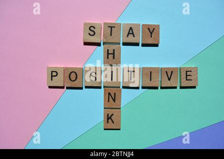 Stay, Think, Positive, words in crossword form isolated on pastel coloured background Stock Photo